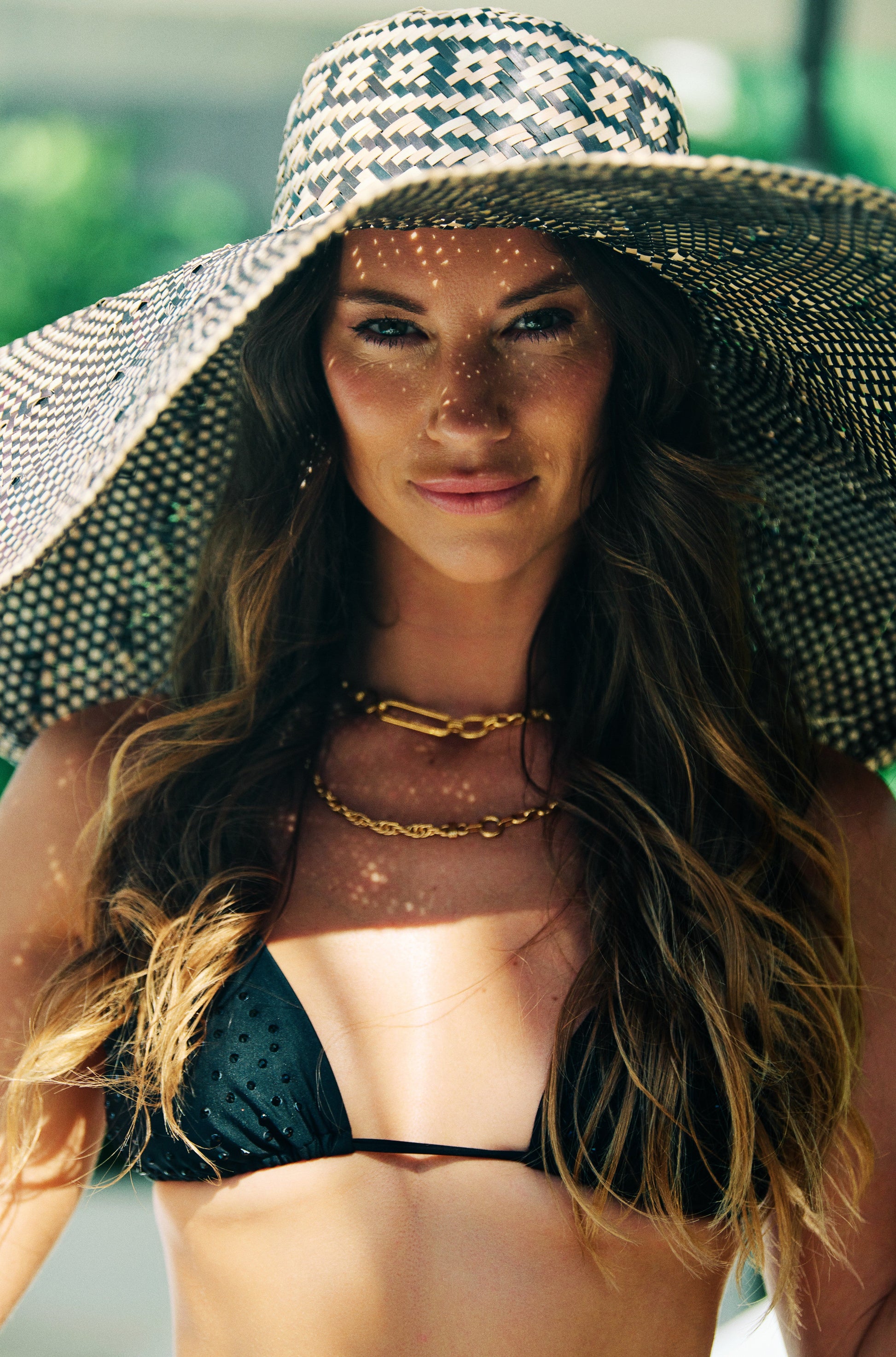 Woman wearing a black bikini sexy triangle bikini model luxury swimwear resortwear