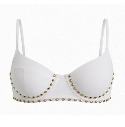 White underwire bra with thin straps and gold metallic stud embellishments along the cups and lower band, shown against a plain white background.